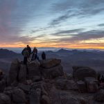 Travellers watching sunrise on Mount Sinai