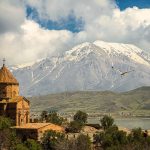 Akdamar Church on Lake Van with snow-capped mountains